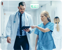 Doctors walking and pointing at chart