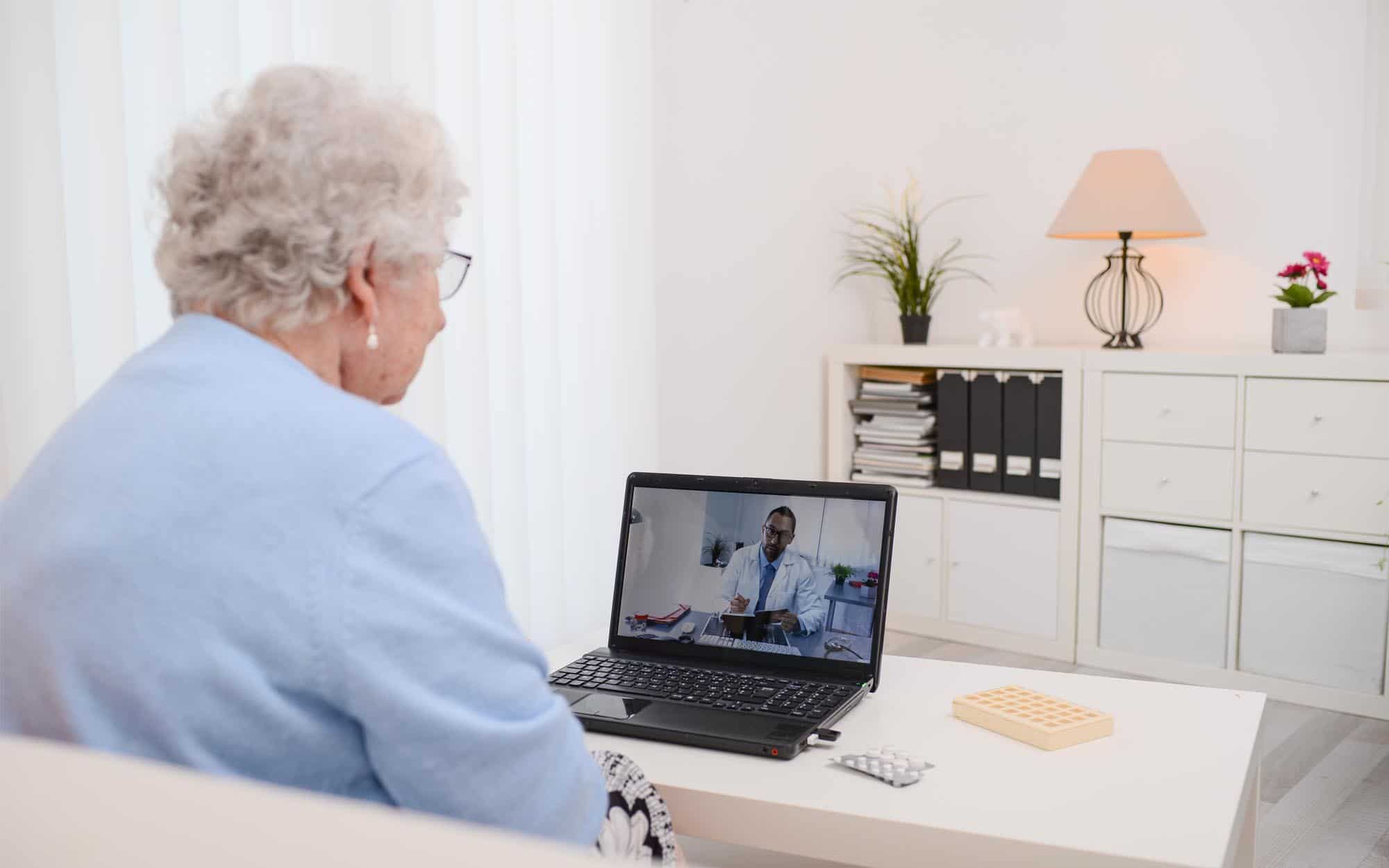 elderly senior woman, having a remote medical consultation with her doctor